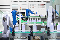 A bottling factory manufacturing line with four automated articulating robot arms